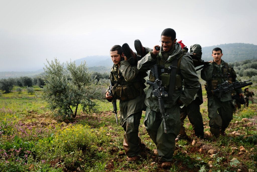 IDF soldiers conducting training exercise in field, preparing for operation