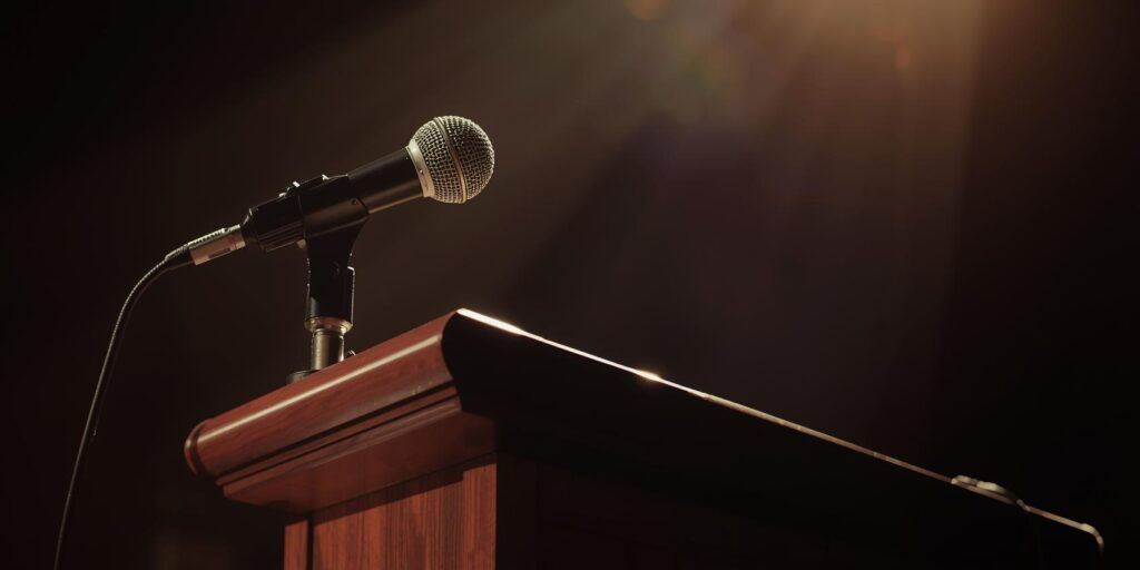 empty podium and microphone symbolizing Charlie Kirk’s public voice and legacy