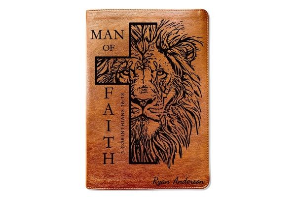 Personalized NLT Reference Bible for men with brown leather-like cover, engraved lion and cross design, and custom name inscription.